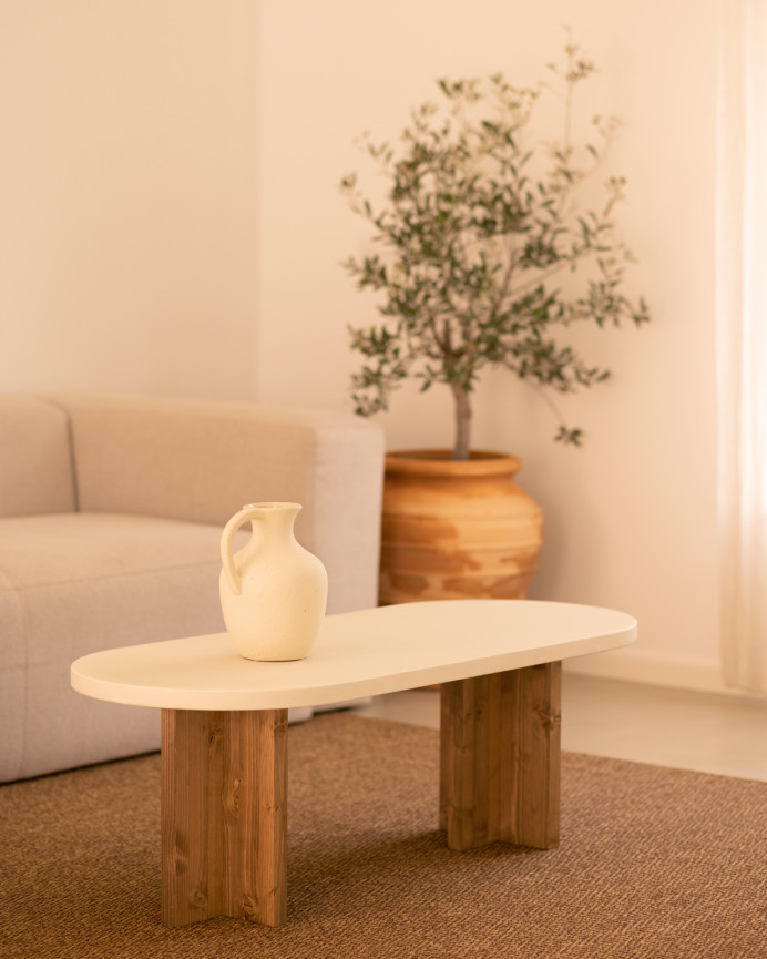 Mesa de centro de microcemento en tono blanco roto con patas de madera tono roble oscuro de 120x50cm