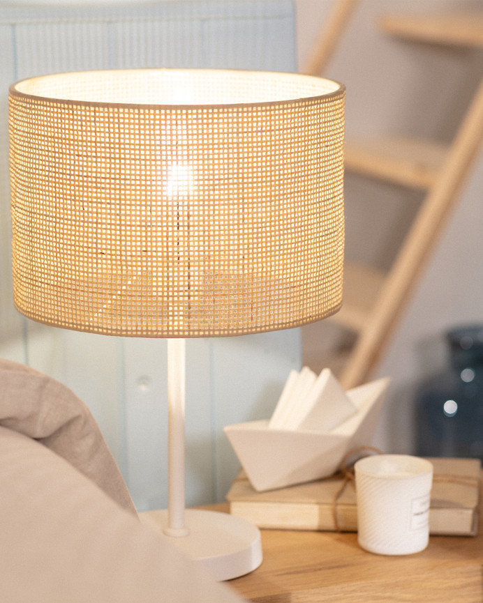 Lampe de table composée d'une base en métal blanc et d'un abat-jour en rotin